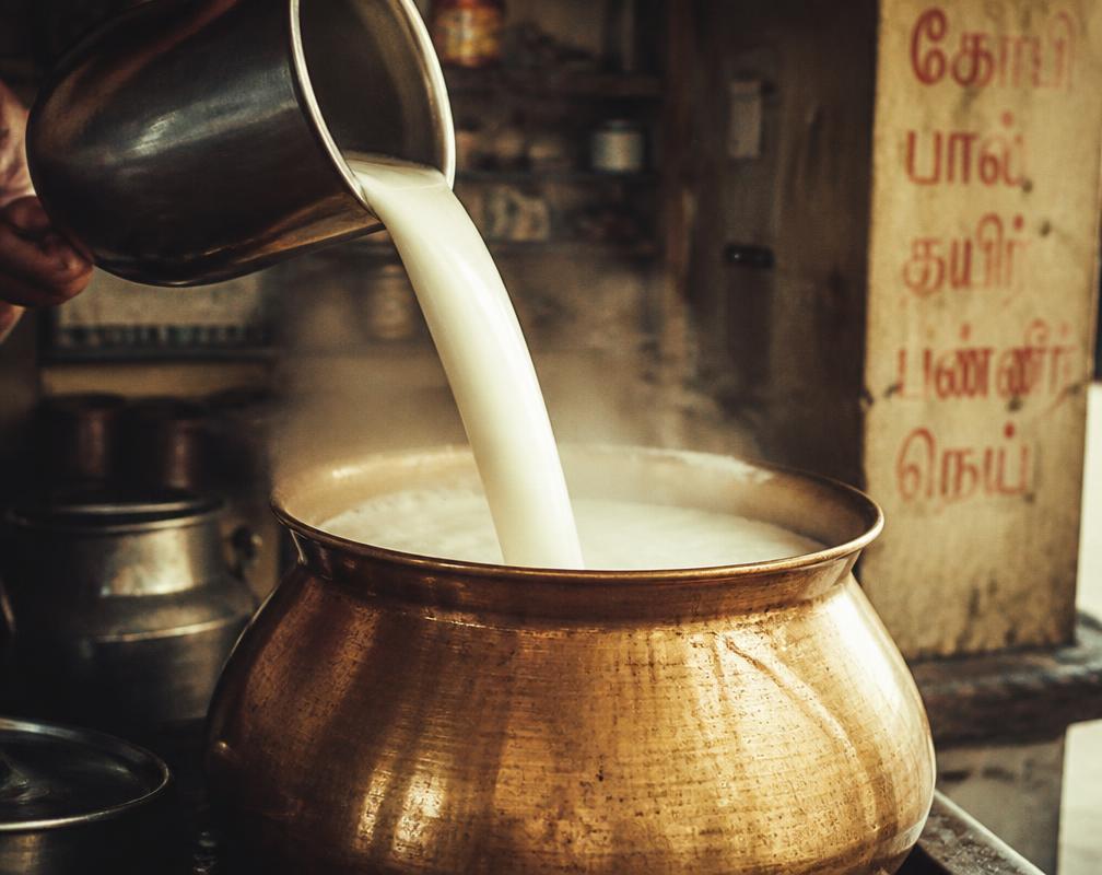 Fresh milk poured into a brass pot